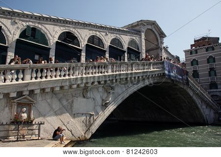 Rialto Bridge In Venice Italy With Tourists
