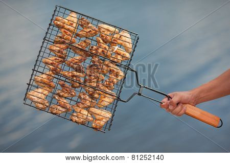 Meat on a grill against water