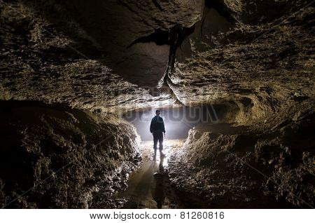 Cave with light and man exploring