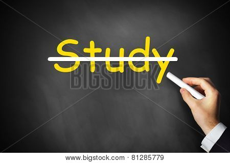Hand Crossing Out Study Written On Chalkboard