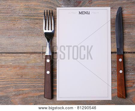 Menu sheet of paper on rustic wooden surface background