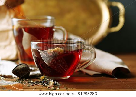 Beautiful vintage composition with herbal tea, on wooden table
