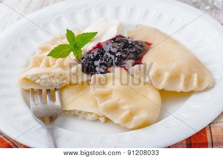 Homemade Dumplings With Blueberry Jam And Cream
