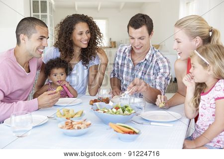 Families Enjoying Meal Together At Home