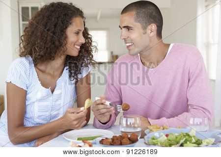Young Couple Enjoying Meal At Home