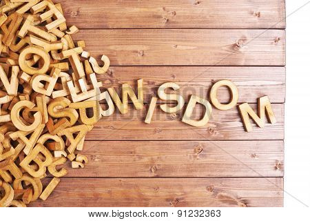Word wisdom made with wooden letters