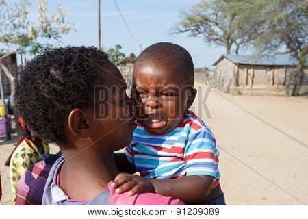 Crying Namibian Child With Mother