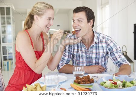 Young Couple Enjoying Meal At Home