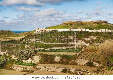 Panoram View On Fields And Lighthouse On The Top Of Mountain. Gozo Island, Malta.