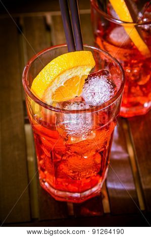 Spritz Aperitif Aperol Cocktail With Orange Slices And Ice Cubes On Color Disco Light Background
