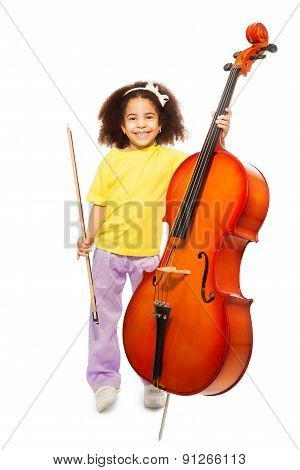 Smiling African girl holding cello and fiddlestick