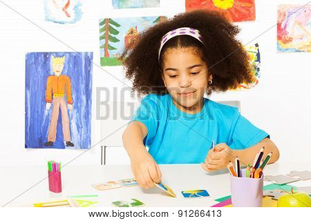 African girl plays developmental game putting card