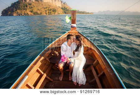 Bride And Groom Kiss In Longtail Boat