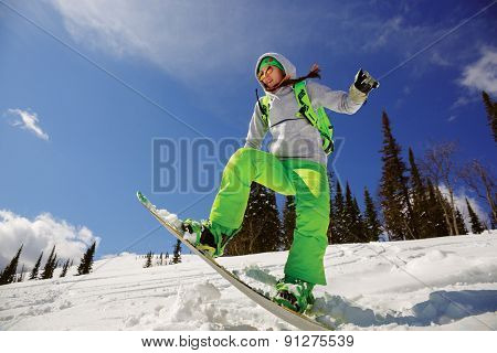Snowboarder jumping through air with deep blue sky in background