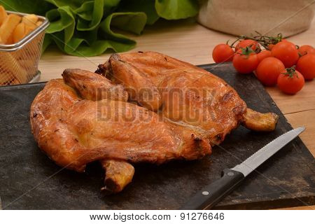Grilled chicken on hot grill stone.