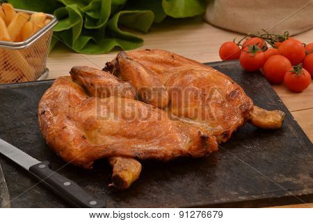 Grilled chicken on hot grill stone.