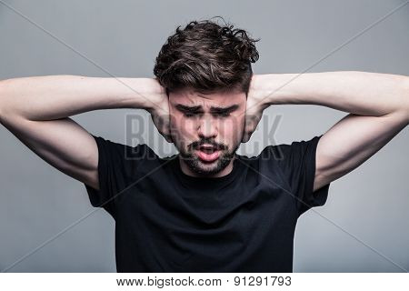 I need silence. Frustrated young man in shirt