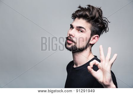 Young man in  black T-shirt shows gesture ok