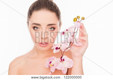 Portrait Of Sensetive Young Woman With Orchid On White Background