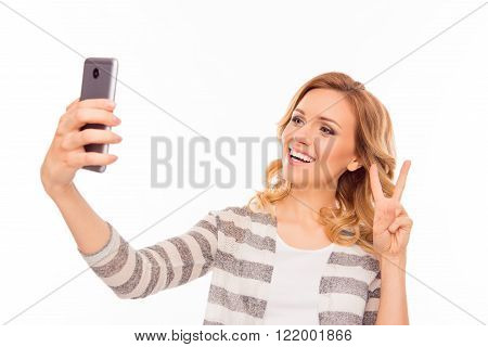 Young Woman  Making Selfie On Her Smartphone And Showing Two Fingers