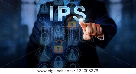 Corporate systems administrator is pushing IPS on a touch screen. Information technology and computer security concept for an intrusion prevention system that blocks malicious network connections.