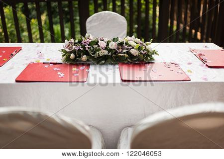 Wedding solemnisation ceremony with table top decorated with flowers.