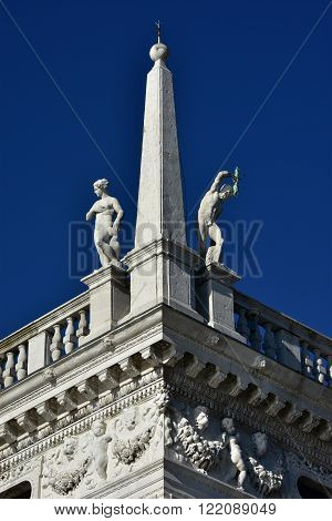 Details and statues from the corner of Biblioteca Marciana (St Mark Library) designed by Jacopo Sansovino in the 16th century in Saint Mark Square