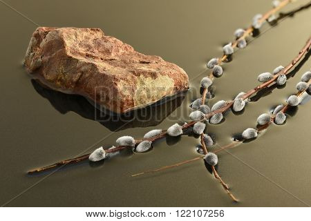 willow branch and a cairn in the water
