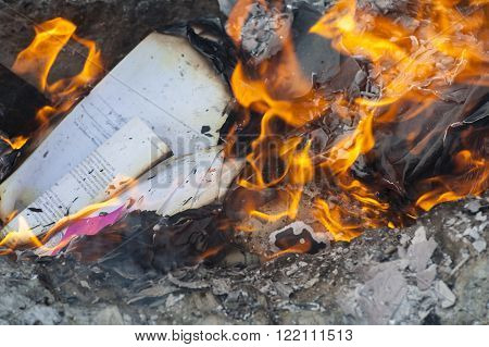 Burning office white paper in bonfire outside