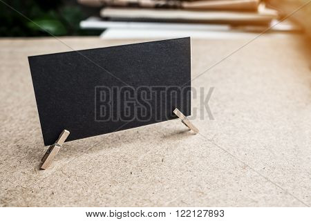 Black textured business card on clothes pin
