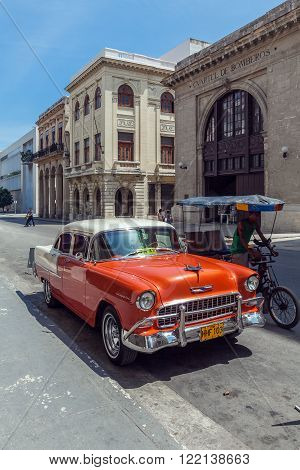 HAVANA, CUBA - APRIL 1, 2012: Orange Chevrolet vintage car in front of Museo de los Bomberos