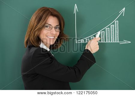 Young Happy Female Teacher Holding Chalk
