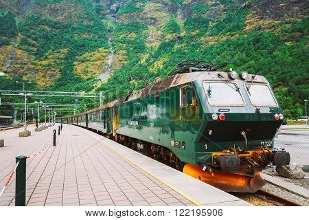 Flam, Norway - August 2, 2014: Flamsbahn In Flam, Norway. Green Norwegian Train On Railway. Famous Railroad