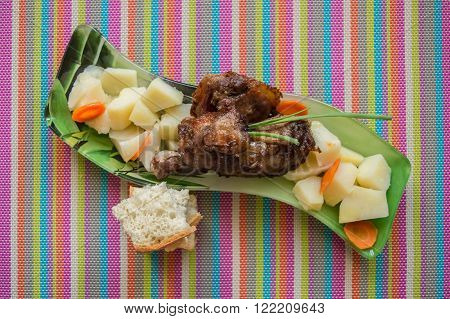 Baked potato with slices of duck on a platter. Top view