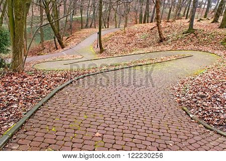 Park paved walkway that runs steeply down early spring evening in Lviv Ukraine