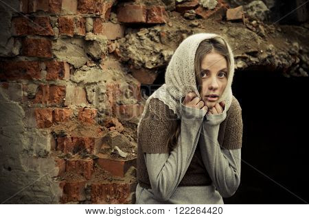 Young Girl Dressed In The Poor Sweater And Scarf