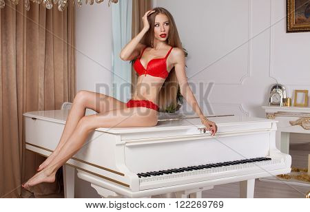 Sexy blonde woman in red lingerie. Hot slim woman.