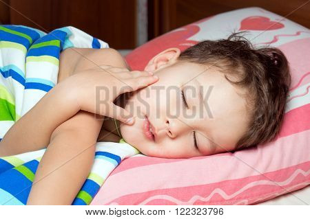 Little boy sleeping in his bed. Morning baby.