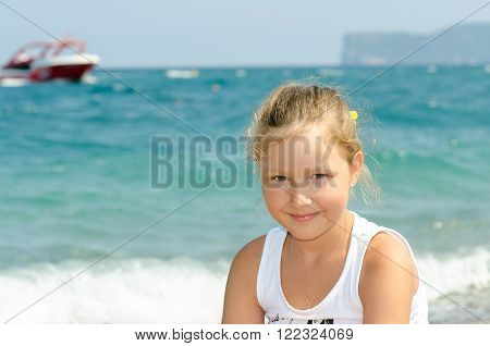 Portrait of a girl in nature. Summer. Smile of the Child. Beach.