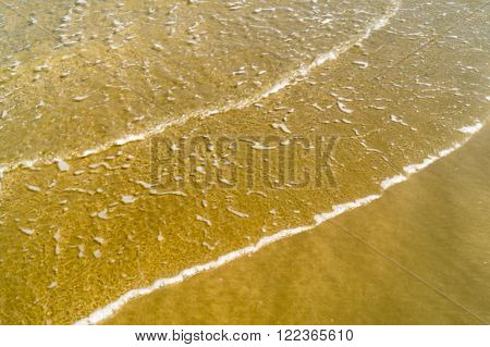 Wave sea water on the beach .