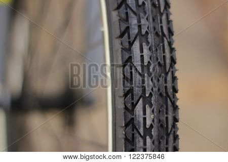Photograph of a bicycle tire closeup and blurred backgronud