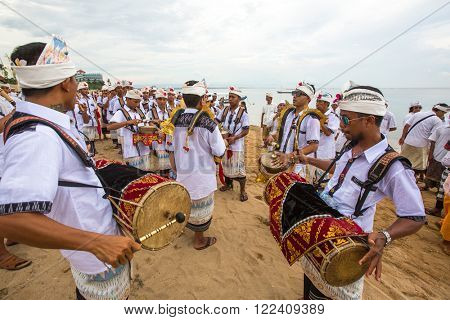 SANUR, BALI - MAR 18, 2016: Unidentified local people during performed Melasti Ritual. Melasti is a Hindu Balinese purification ceremony and ritual is held several days prior to the Nyepi holy day.