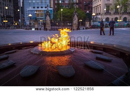 Police guards Centennial Flame & Peace Tower in Parliament building complex Ottawa