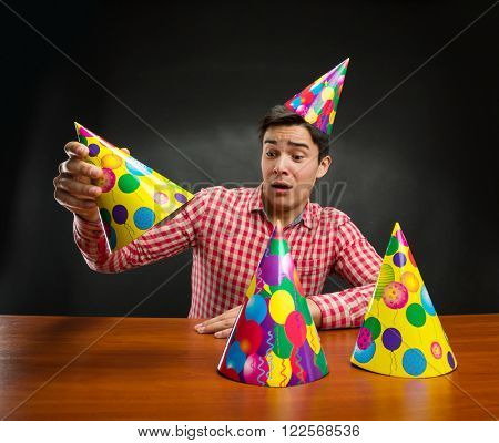 Man playing with Birthday hats