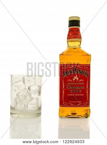 Winneconne, WI - 19 March 2016: A bottle of Jack Daniel's fire whisky with a glass of ice.