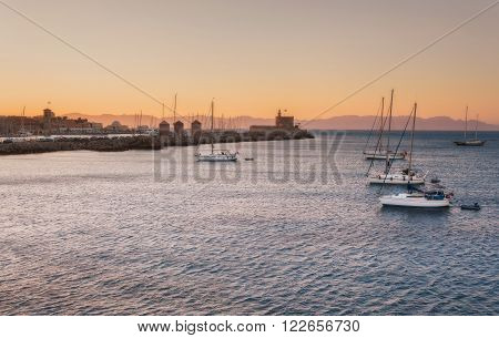 Yachts at sunset in the Mediterranean Sea near the Mandraki harb