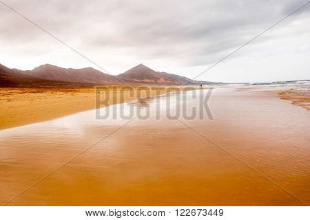 Cofete beach at the cloudy and foggy weather on Fuerteventura island in Spain