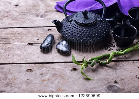 Traditional asian tea set on aged wooden background. Selective focus. Place for text.