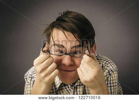 
Cross-eyed teenage boy with glasses