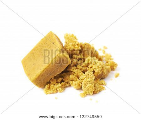 Crushed yellow bouillon stock broth cube isolated over the white background
** Note: Shallow depth of field